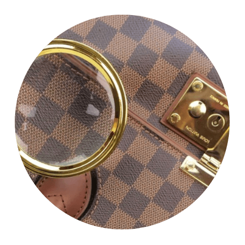A magnifying glass held over a designer item