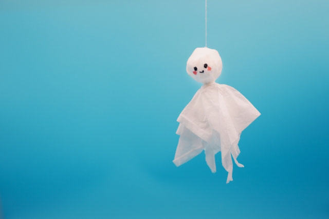 One Teru Teru Bozu hanging against a blue background