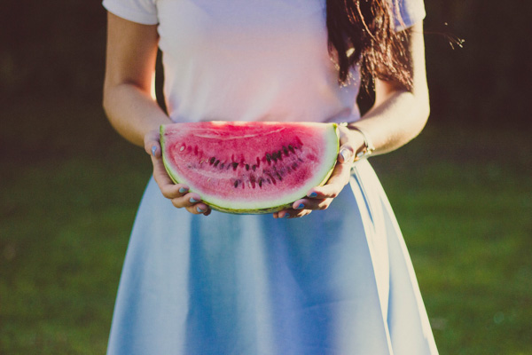 Woman holding a cut watermelon