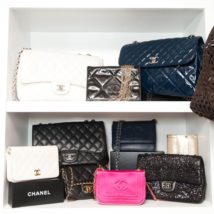 Chanel bags lined up on a shelf inside a closet