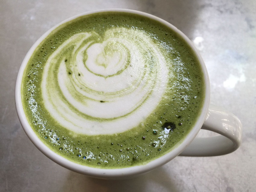 A cup of Matcha with simple latte art seen from above