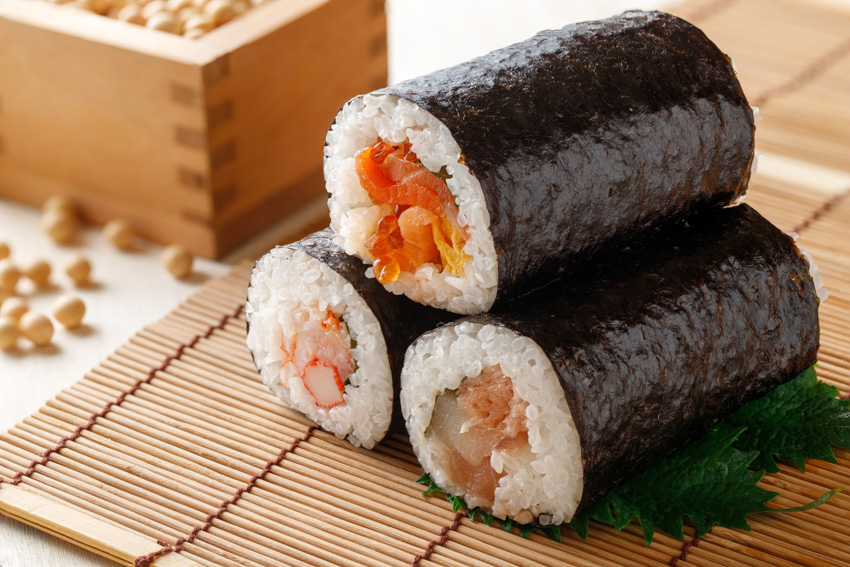 Close up of sushi rolls on a bamboo sushi roll mat