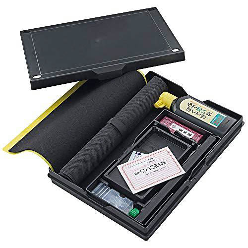 A basic calligraphy set with brushes ink and inkstone in a compact package.