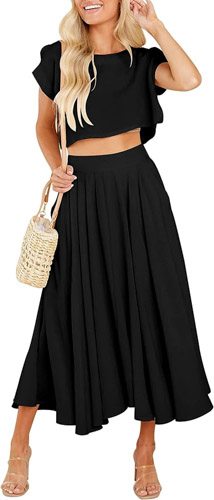 Woman in black crop top and black pleated long skirt