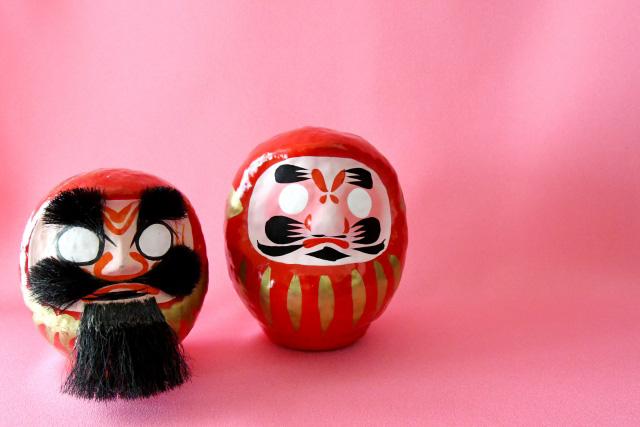 Two daruma dolls