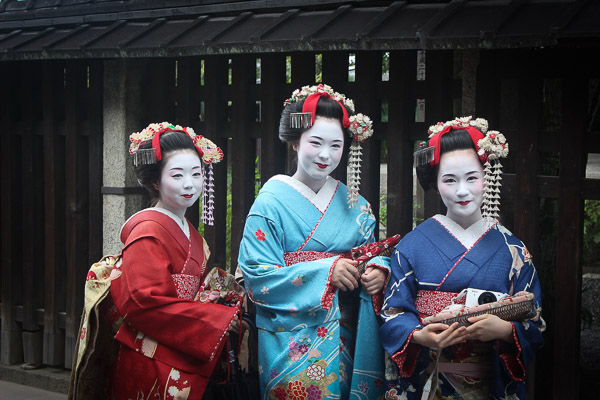 Three women dressed in traditional Japanese Maiko outfits