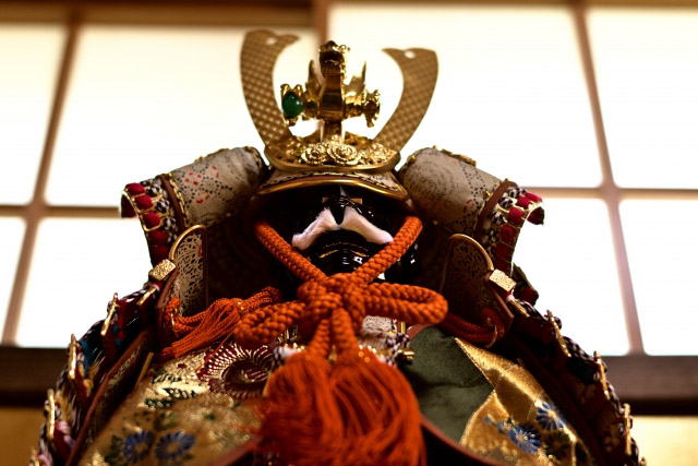 Close up of a samurai helmet on display in a Japanese style room