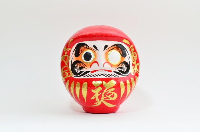 Typical daruma in red with only one eye painted and a beard