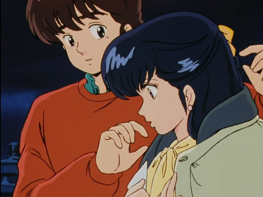 Close up of Godai and Kyoko, Godai putting his jacket on Kyoko's shoulder.