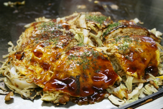 Close up of a Japanese savory pancake called Okonomiyaki