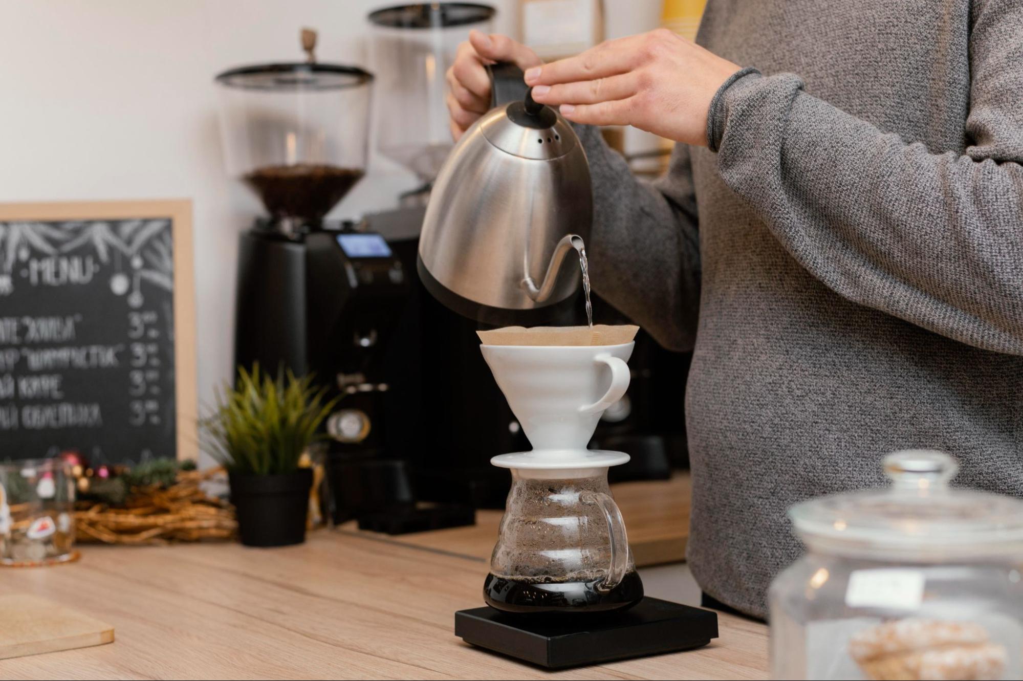 A person hand brewing coffee in a coffee shop