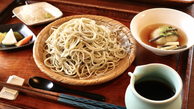 Tray with a soba set and chopsticks in the foreground