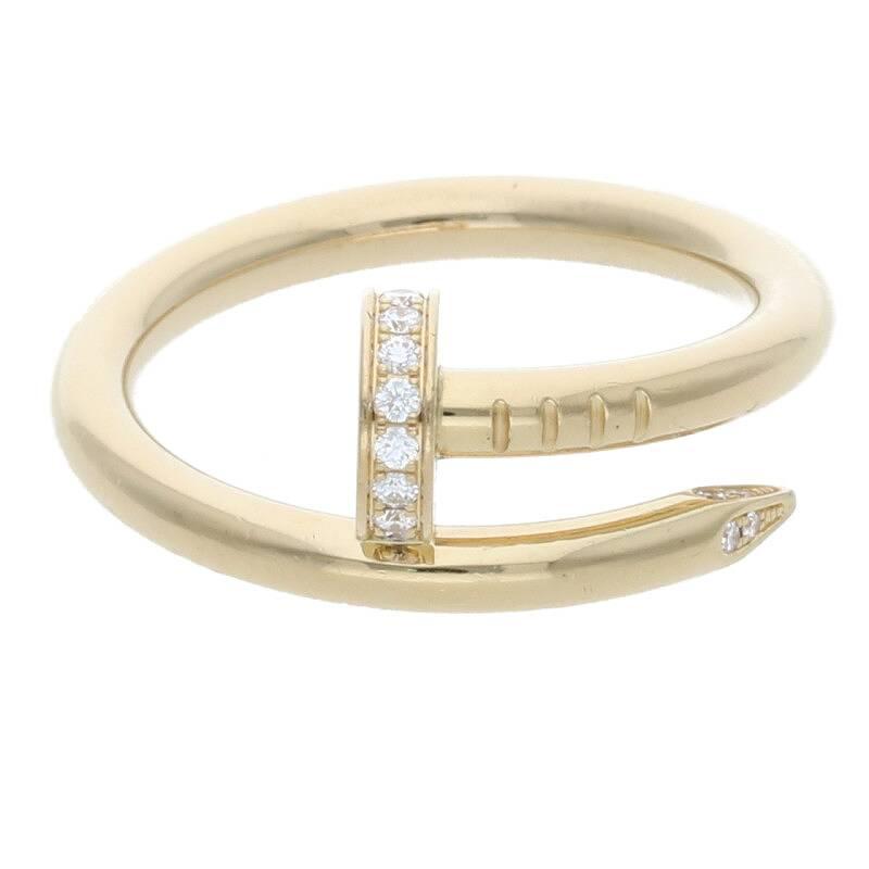 Cartier Juste Un Clou ring in 18K gold with the shape of a bent nail with diamonds lining the head