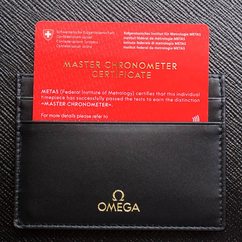 Close up of a red METAS certificate in a black Omega leather case