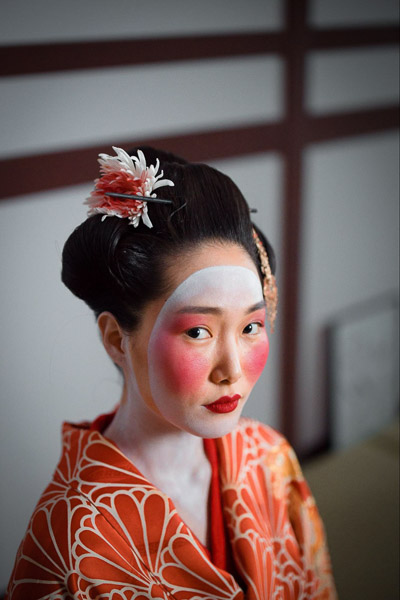Close up of a woman with Geisha like face make up