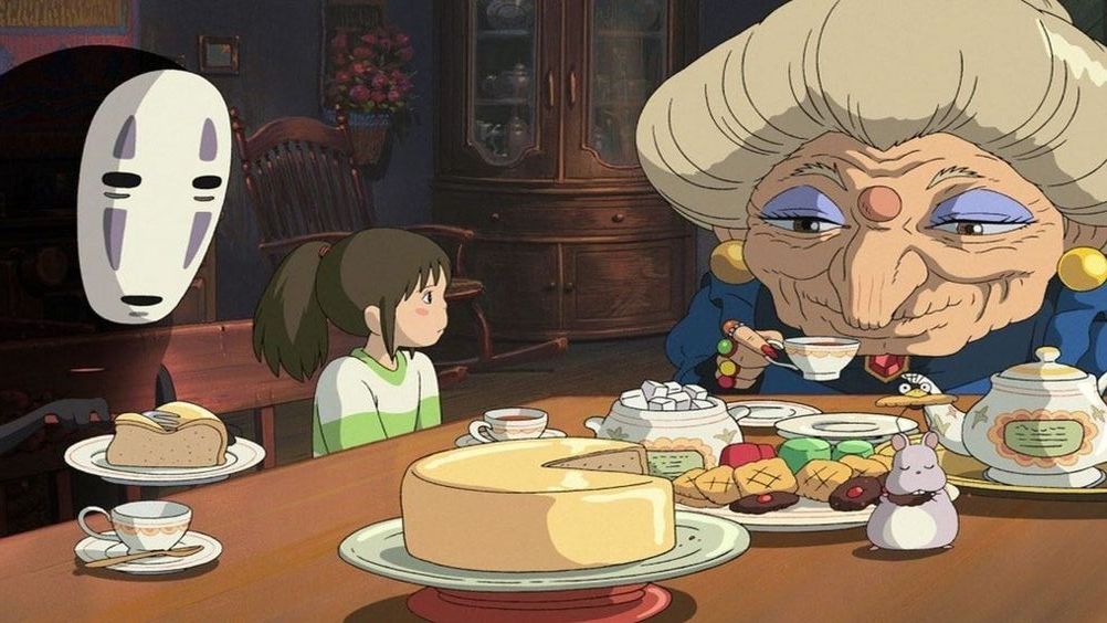 Scene of a animation movie made by Studio Ghibli where 3 of the main characters are sitting at the table eating