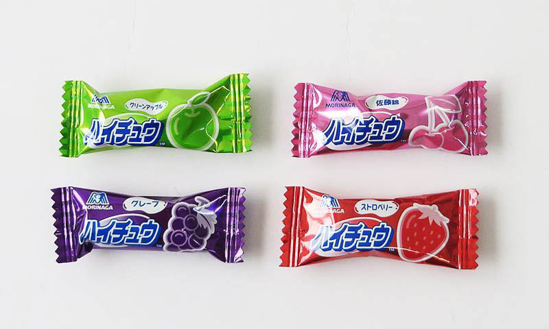 Four Hi-chew bite sized packages. Tastes are apple, grape, cherry, strawberry.