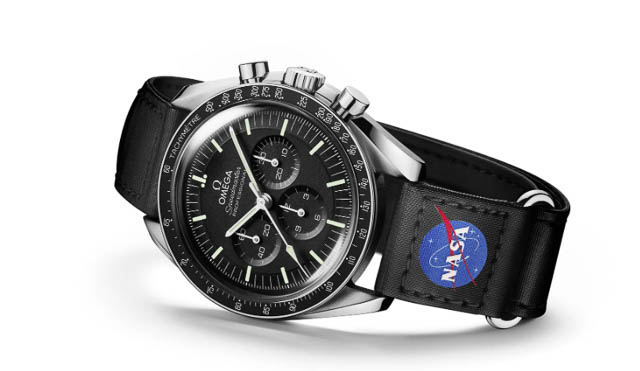 The Omega Speedmaster Moonwatch with a black wrist band featuring the NASA logo