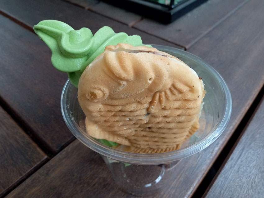 Taiyaki with matcha ice cream in a clear plastic bowl