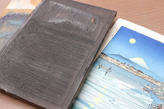 A woodblock and the print made with same woodblock depicting Mount Fuji and a lake