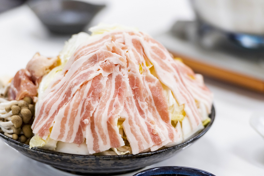 Chanko nabe filled to make a small pile of food sticking up out of the pot