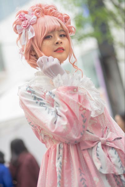 Girl dressed in a pink lolita fashion dress