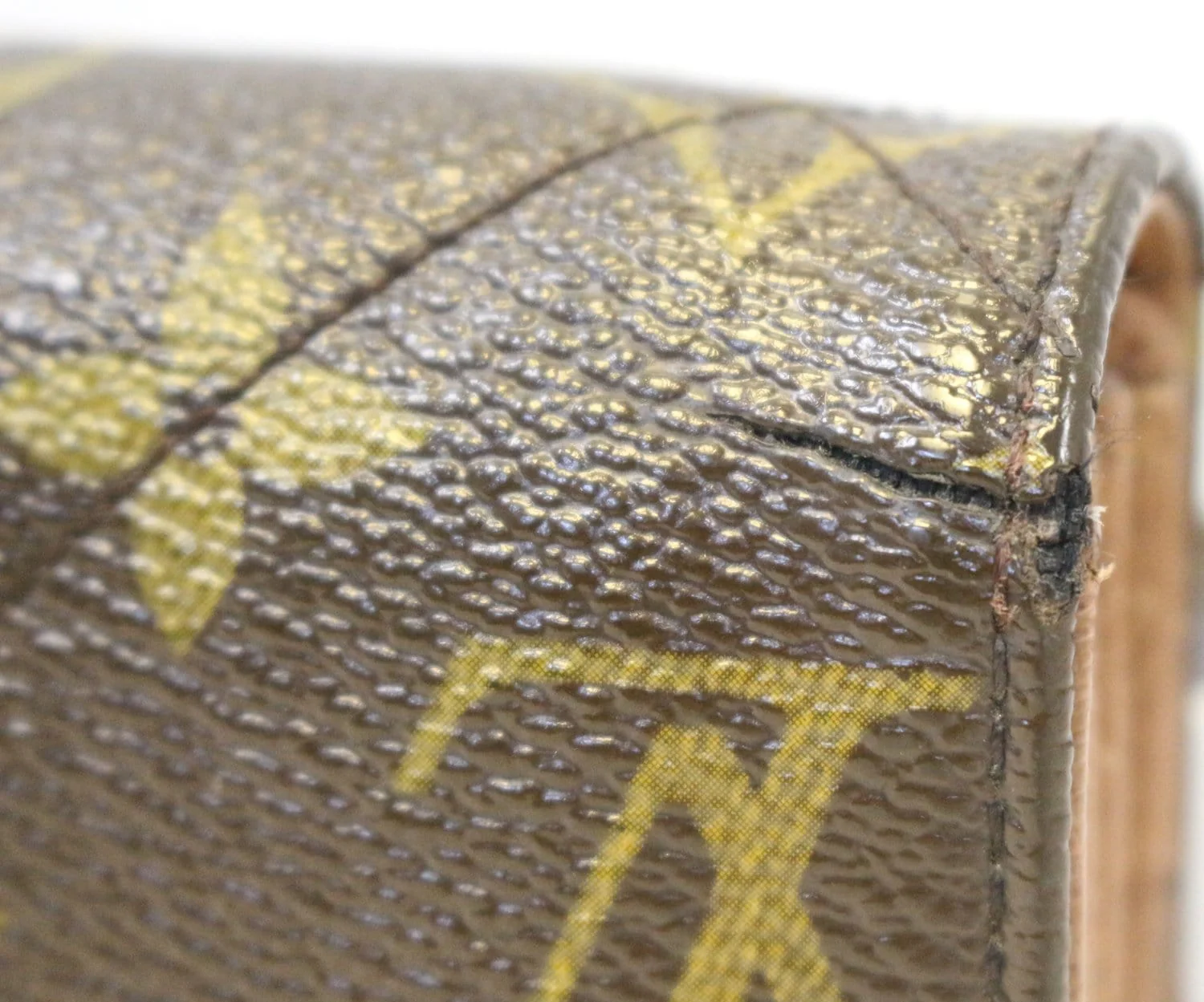 Louis Vuitton monogram canvas with a crack on the corner