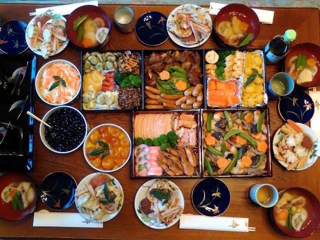 A table fulfilled with typical dishes served during New Years in Japan