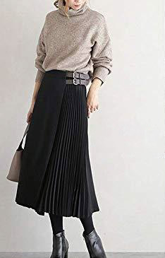 Woman wearing sweater with long pleated skirt