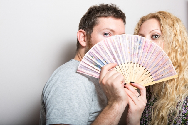 Couple holding a fan together