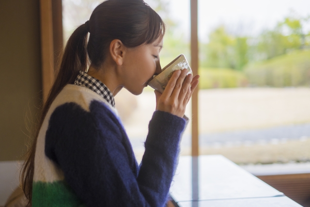Woman drinking Matcha tea in a chawan
