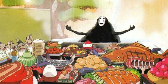 Scene of a animation movie made by Studio Ghibli where of the main characters is sitting by a table full of different dishes