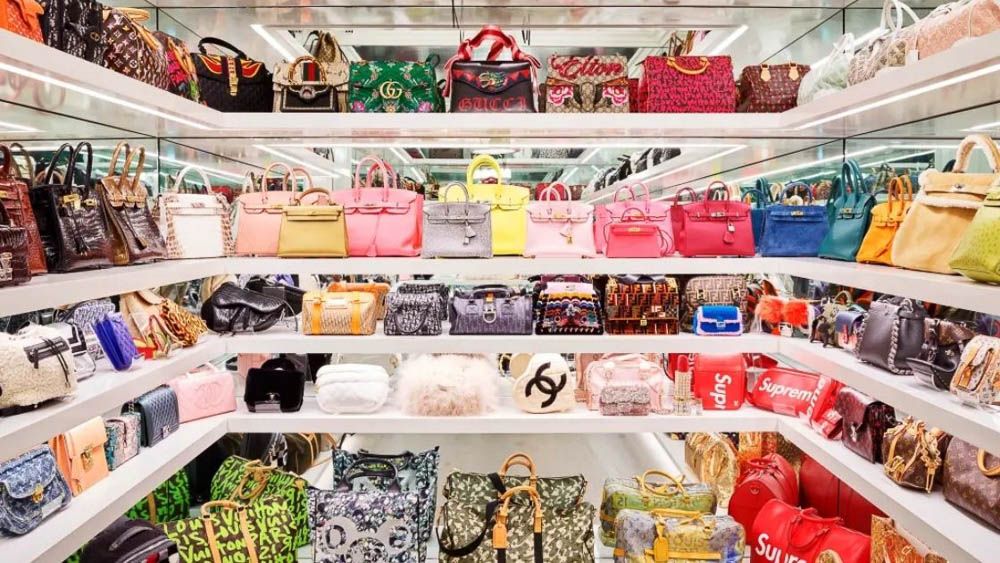 A luxury bag store with shelves filled with designer bags from floor to ceiling.