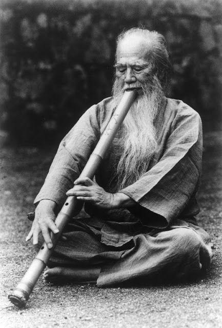 An image of a man playing the Japanese instrument Shakuhachi