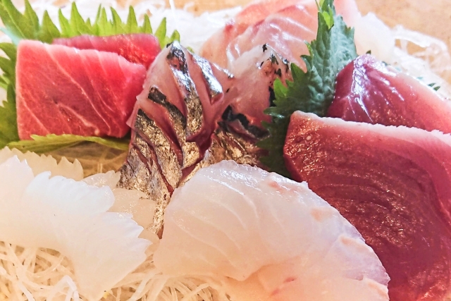 Different cuts of sashimi fish on a plate