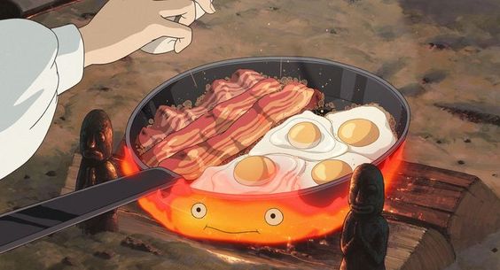 Scene of a animation movie made by Studio Ghibli where someone is cooking multiple eggs and bacon