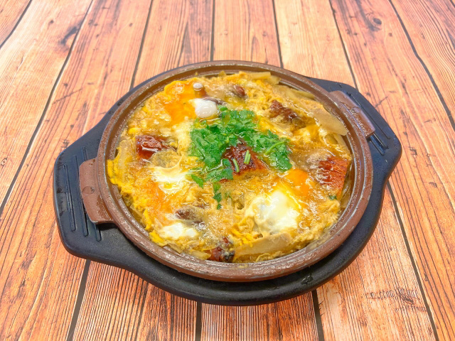 Nabe pot filled to the brim with food on a wooden table