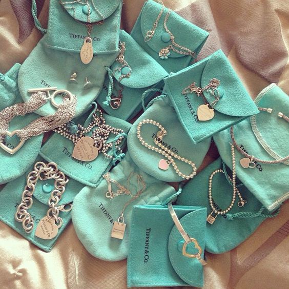 Collection of Tiffany & Co jewelry pieces combined with their well-know Tiffany blue pouches