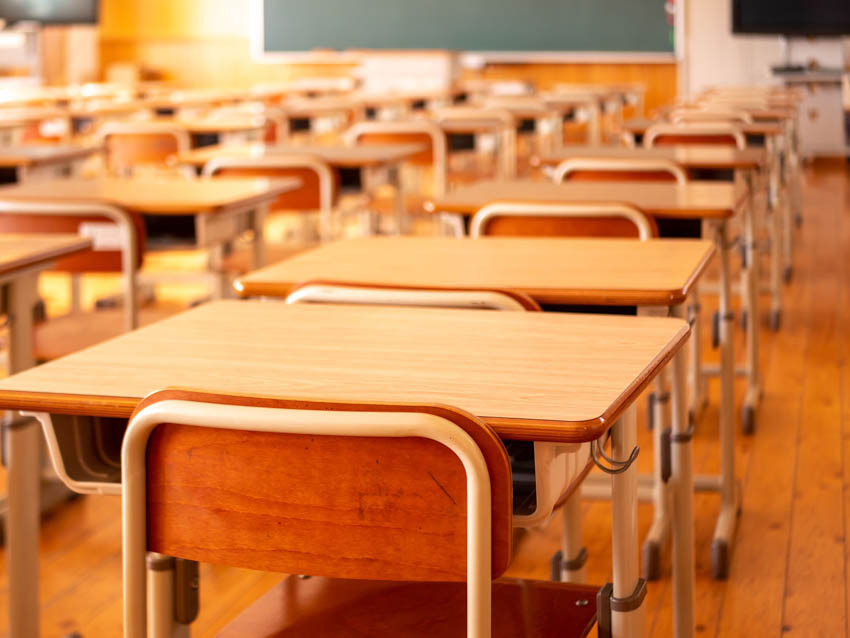 Typical Japanese school classroom with rows of school desks but no students.