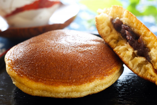 One whole dorayaki and one dorayaki cut in half.