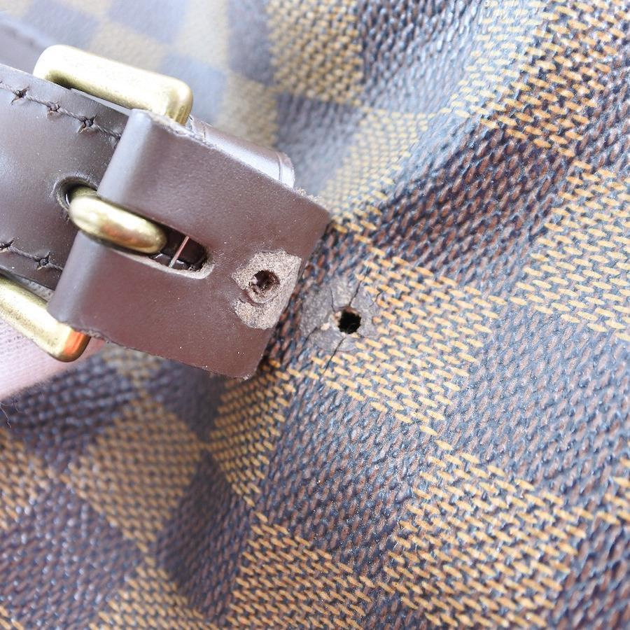 Louis Vuitton Chelsea Bag with a broken rivet and cracks on the canvas