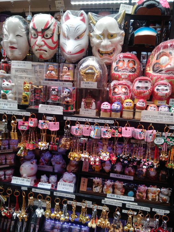 A wall covered with different types of common souvenirs you can find in Japan, from key-chains to foxy shaped masks. 