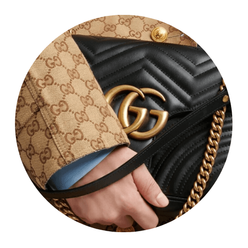 A person holding a Gucci Marmont bag
